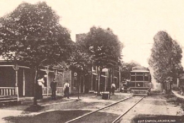 POSTCARD VIEW IN ARCADIA, INDIANA SHOWING UNION TRACTION OF INDIANA DEPOT BEHIND THE TREES
